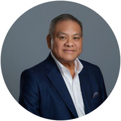 Man in blue suit, smiling portrait photo.